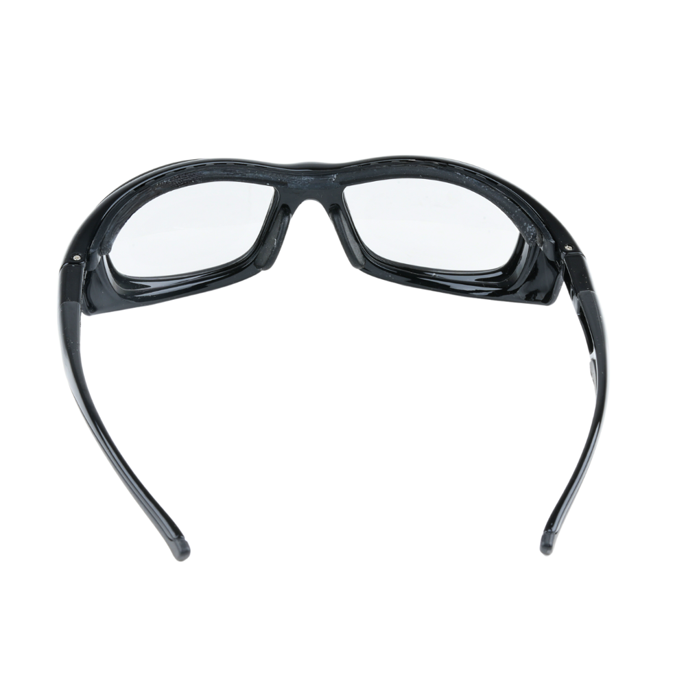 Top view of Mallcom Altair safety goggles featuring a clear curved wraparound lens, black protective frame, adjustable side temples, and a removable black eyebrow protector on a white background.
