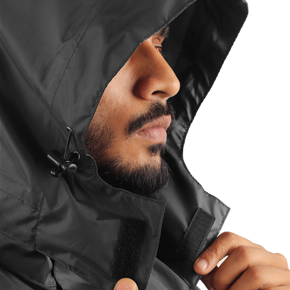 Velcro hood attachment on the ARCUS olive and black rainwear jacket for secure fastening and easy hood removal.