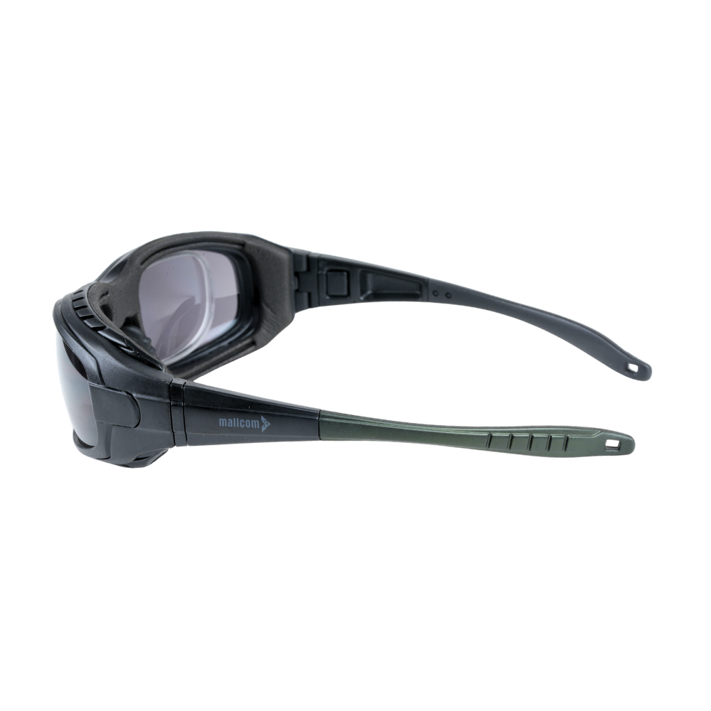 Mallcom Avior safety goggles side view with a clear wraparound lens, black frame, and adjustable temples on a white background.
