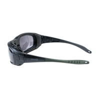 Mallcom Avior safety goggles side view with a clear wraparound lens, black frame, and adjustable temples on a white background.
