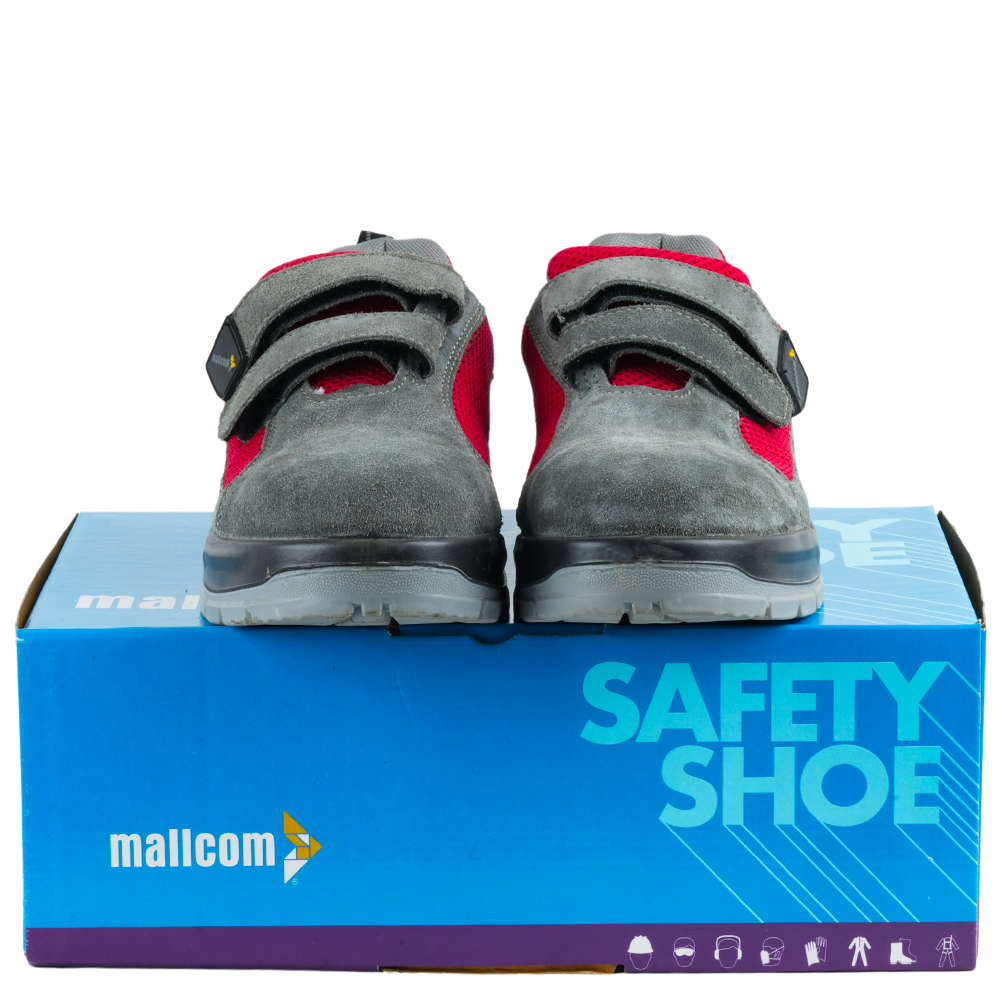 Grey and red safety shoes with suede leather and mesh upper displayed on top of the product box.