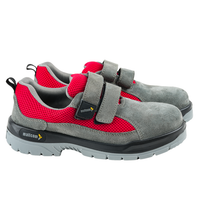 Side view of grey and red low ankle steel toe safety shoes with suede leather, mesh upper, and Velcro closure.