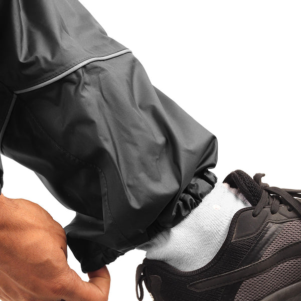 Close-up of the elasticated ankle cuff on the black STRATUS rainwear pants.