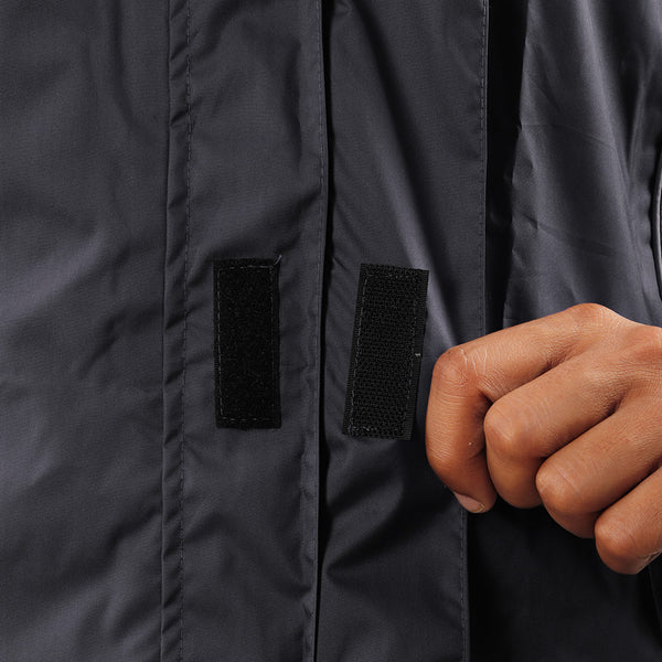 Velcro-secured storm flap on the black STRATUS rainwear jacket for added weather protection.