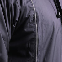 Silver piping detail on the navy blue STRATUS rainwear suit for enhanced visibility and style.
