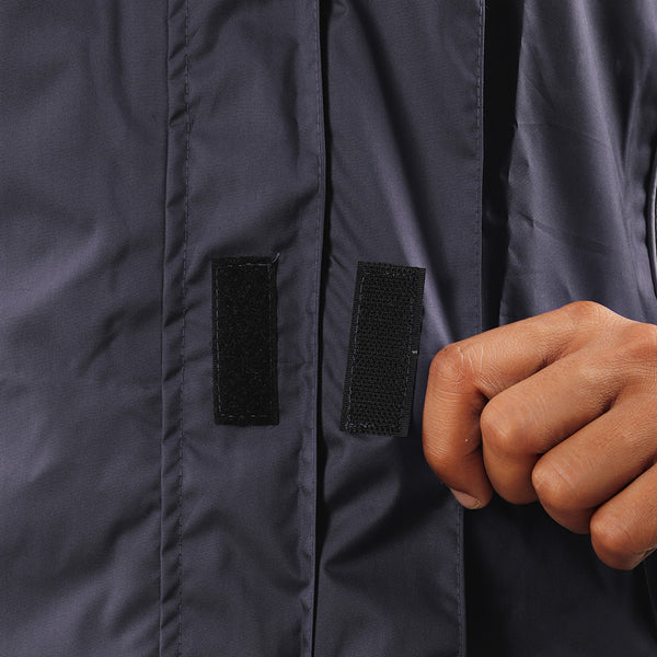 Velcro-secured storm flap on the navy blue STRATUS rainwear jacket for added weather protection.