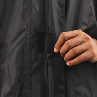 Velcro-secured storm flap on the black NIMBUS rainwear jacket for added weather protection.