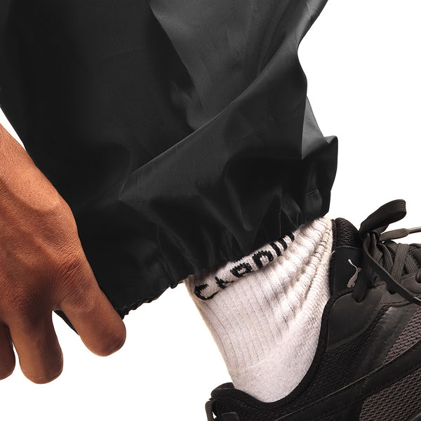 Elasticated ankle cuff on the black NIMBUS rainwear pants for a secure and comfortable fit.