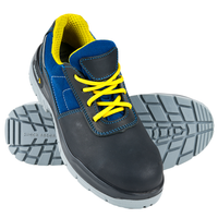 A pair of PEDROFELES safety shoes with blue nubuck leather and yellow lacquered straps, featuring a gray sole with black anti-static detailing.