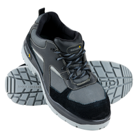 A pair of black safety shoes with a low ankle design, featuring a black microfibre upper, a black mesh lining, a dual injected PU sole, and a steel toe.
