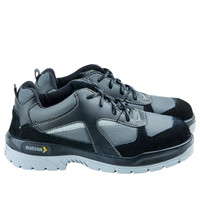 Side view of a black low ankle safety shoe showing the upper design and sole construction.